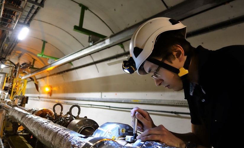 Michał Krupa installing the prototype system for measuring beam intensity at the Large Hadron Collider