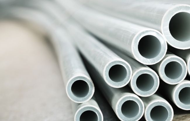 Overview photo: the tips of a dozen white polymer tubes.