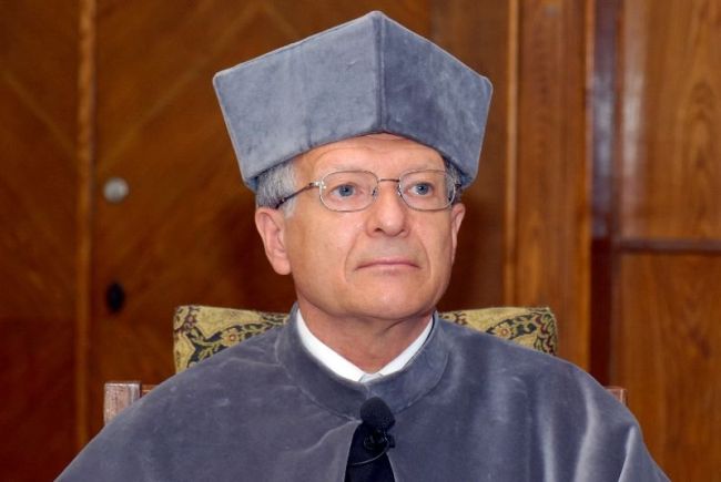 Portrait photo: Prof. Erick Vandamme in grey gown at the ceremony of awarding the DHC title of TUL.