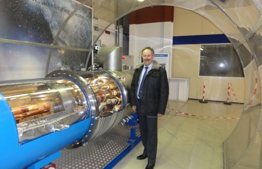 Prof. Piotr Borkowski in a specialised laboratory by a transparent tube.