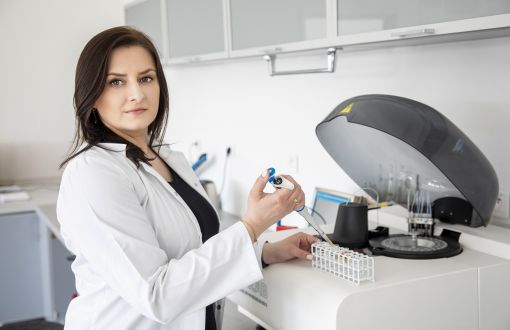 Katarzyna Pietrzak w białym fartuchu w laboratorium
