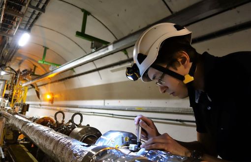 Michał Krupa installing the prototype system for measuring beam intensity at the Large Hadron Collider