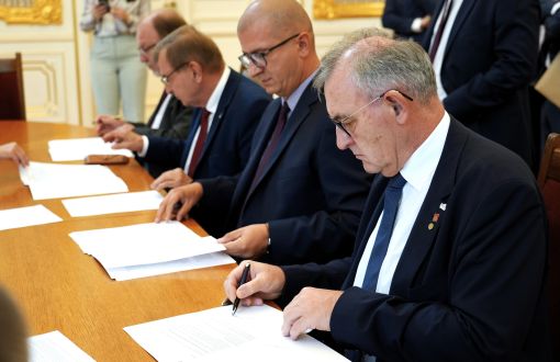 Men sign documents